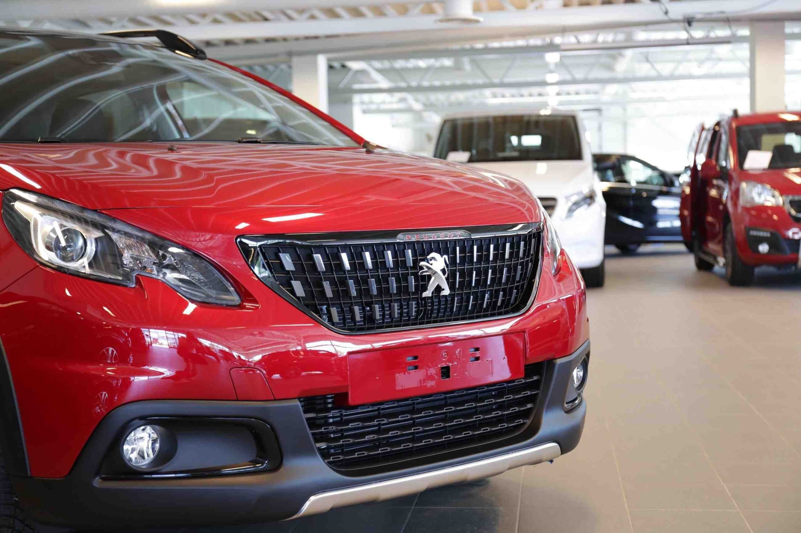 Fronten på en rød bil av merket Peugeot